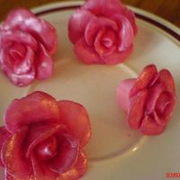 Dsc00352.jpg firts time making fondant roses..i painted it with cotton candy sparkle dust...i used this for the xtening cake i made in my gallery..