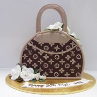 Lv !2 inch round cut off and iced in choc fondant , not my design , love it all the same , pic does not do it justice , looked great
