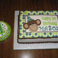 Our Little Monkey 1st Birthday Cake for a friend's son. Iced with buttercream. Monkey, name, and polka dots are MMF. The sides are imprinted with the...