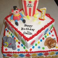 Circus Cake - First Birthday Circus themed cake for a 1 year old. Buttercream with MMF fondant accents. Popcorn made from mini-marshmallows. Peanut border made with...