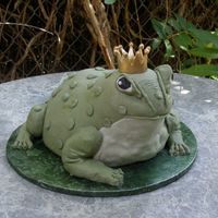 Billy The Bull Frog A hand carved cake in 3 d of a bull frog. Billy is adorned with a gold Sugar crown.