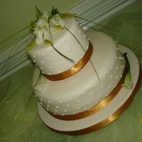 Calla Lilies Top teir is a dummy second tier is a Mocha cake with mocha buttercream filled with ganache. Covered in marzipan and fondant. Fresh calla to...