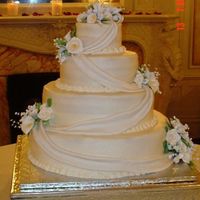Calla Lily Wedding 4 tiers of White Almond Sour Cream Cake. Bottom tier has raspberry filling, 3rd tier has cappaccino mousse filling, top 2 tiers have white...