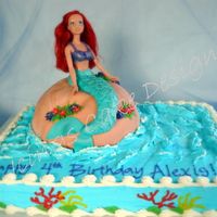 Alexis's Ariel I used the whole Ariel doll wrapped in plastic wrap. I used the wondermold pan, carved, & covered in marbled fondant for the rock....