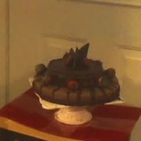 Chocolate-Dipped Strawberries Two tier chocolate cake with chocolate dipped strawberries.