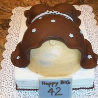 Pregnant Mom's B-Day Cake Choc w/rasp 9x13, white w/rasp and a plastic baby inside mommy bump.modeling chocolate shirt w gumpaste flowers. The mom had a great sense...