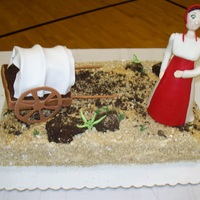 Pioneer Woman Cake Cake ball boulders, shredded wheat dirt, gumpaste figure & wagon. Trying to develop my figure making skills.