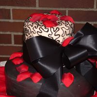 Black & White Chocolate MMF covering chocolate cake on bottom layer. White chocolate fondant covering a coconut cake on top covered in cornelli lace....