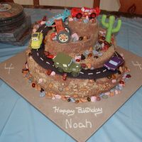 Cars Themed Cake A cars themed cake I make for a neighbor's child, 2 tiers of double fudge chocolate, 1 tier of white cake and the smallest cake under...