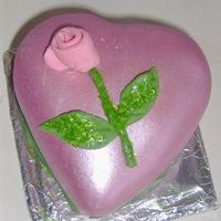 Valentines Day Heart Shaped Miniature Cake Heart shaped Miniature cake. Covered with fondant them painted with luster dust. Molded rose with some green edible glitter. Thanks for...