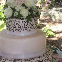 Pink, Black And White Wedding Cake this was my first wedding cake. the entire cake was covered with pink fondant. I used white satin ribbon for the bottom of each tier. The...