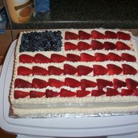 Fourth Of July Cake Buttercream icing with blueberries and strawberries. Used the Pillsbury Funfetti cake mix to imitate the fireworks