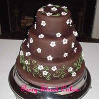 Chocolate Fondant Wedding Cake Chocolate fondant with pink gumpaste peach blossoms and green royal icing piping. Cake was chocolate and vanilla with raspberry filling