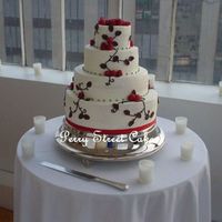 Raspberry Wedding Cake Red velvet cake with raspberry filling covered in buttercream. Chocolate modeling clay leaves, chocolate buttercream piping, fresh...