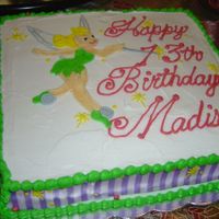 Tinkerbell The side of the cake is purple ribbon. I drew Tinkerbell on top, and was happy with most of it except for her face. It obviously doesn'...