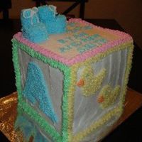 Baby Block Cake Made with layered 8" square. All done in buttercream. Booties on top are decorated marshmallows.