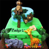 Jungle Themed Baby Shower Cake I made a zebra and lion (not pictured, on the sides of the cake) elephant, giraffe and monkeys. The little baby in the leaf was a fun...