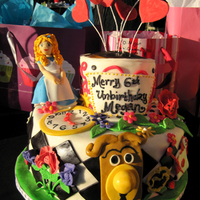 Alice In Wonderland Alice and detailed flowers made out of gumpaste. All other decorations were fondant. The top tier is actually a tea cup but the handle was...