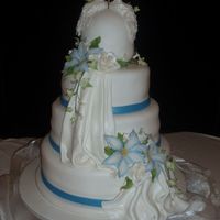 4 Tier Fondant Wedding Cake With Draping 4tier fondant wedding cake with fondant ribbon, and draping. Also fondant doves and gumpast flowers