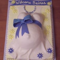 Pregnant Belly This was requested for a baby shower for two expecting mommies. chocolate cake. swiss meringue buttercream. fondant dress and accents.