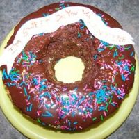 Doughnut 10" round with the centre cut out of it. Melted choc. icing and iced the top for a shiny look and added sprinkles to it