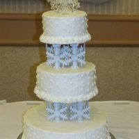 Snowflake Wedding Cake snowflakes are plastic and hot glued to the top of the pillares