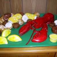 Lobster Dinner Lobster, corn. potatoes, lemons and sausage are yellow cake frosted withbuttercream and covered in fondant painted with food gel.