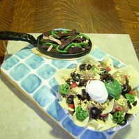 Fajitas And Nachos Yellow Cake covered in MMFpainted with food gel. Nachos are brownies, toppings are mainly fondant. Sour cream, Guacamole and Refried Beans...
