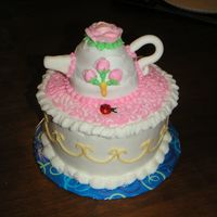 Picture_089.jpg My very first tea pot cake. Cake is white and tea pot is lemon. Everything's buttercream except fondant handle and spout.