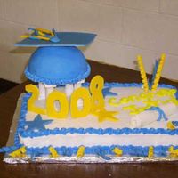 My Nephews Graduation Cake Marble sheet cake with BC icing, French vanilla cap with homemade fondant mortar board, numbers, diploma, and swirly things.