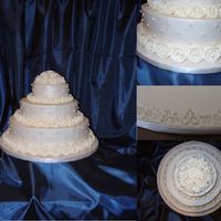 Ring Of Roses The cake is iced in Ivory buttercream and the roses are make out of royal. I covered the board with fondant and then embossed a delicate...