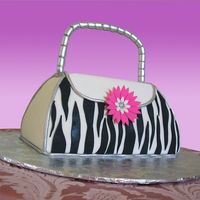Zebra Striped Purse This cake is done in fondant with a gumpaste hanle with a wire all the way through it.