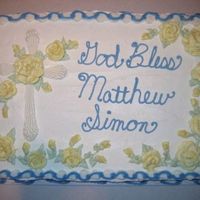 Elongated Shell Cross Cake 1/2 sheet dark chocolate fudge cake with buttercream. All decorations are done in buttercream.