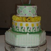 Spring Garden And Pickett Fence (Rachel's Cake) 18" hexagon iced in mint green buttercream with white gumpaste pickets.12" round iced in buttercream with gumpaste flat tulips...