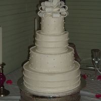 String Of Pearls (Heidi's Cake) Four tier round stacked wedding cake 11"-9" 7"-5". All iced in buttercream. Single Gumpaste pearls on 2nd and top tier...