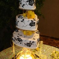 Dramatic Hearts 12-9-6 heart shape wedding cake. All cakes covered in white rolled fondant. Black brushed embroidery vine and leaf designs on cake with...