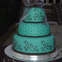 Brazilian Bride's Dream (Fabiola's Cake) Three tier stacked 12"-9"-6" wedding cake. Covered in Aqua tinted rolled fondant. Patterned scrolls on bottom and top tiers...