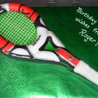For Leo Carved tennis racquet cake from rectangular cake & oval cake; covered in fondant, accents in royal icing and fondant. Tennis balls are...