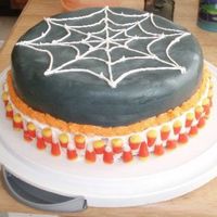 Spider Web For Halloween fondant with buttercream icing. and candy corn's around bottom of cake :)