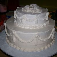 Anniversary Cake i did this for a client for her parents anniversary. its a replica of their wedding cake. very simple but i am sure they were pleased.