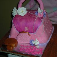 2Nd Purse Cake This is my 2nd purse cake and my first actual order. The cake is almond amaretto frosted with buttercream and fondant. Compact and lipstick...