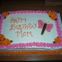 Mom's Bday Cake Orange cake brushed with Grand Marnier filled with rasberry mouse and icing with dream whip icing.