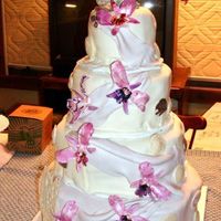 My Wedding Cake Fondant covered, four tier, two layers each, fondant orchids, chocolate shells, dolphin topper. Took about five days all together.