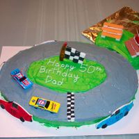Nascar Birthday Cake I made this cake for my dad's 50th birthday. Cars on side of cake and Flag are made out of Rolled marshmello fondant and painted with...