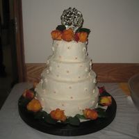 My Grandparent's 50Th Anniversary Cake. The bottom layer is Pumpkin, The second layer is Chocolate. The other 2 are just plain vanilla. I covered the cake in Vanilla Buttercream...