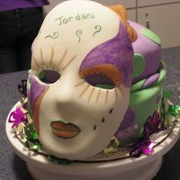 Jordan's Mardi Gras Cake This is my first mardi gras cake. The masks are made of fondant.