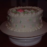 First Cake This was my first cake. BC icing, rose, and leaves. Small RI flowers on top and sides.