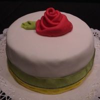 Red Rose fruit cake converd in fondant and with a fondant ribbon rose