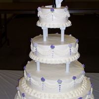 Lavender & Purple Roses Wedding Cake This cake was your basic chocolate and white cake with whipped icing. This cake served 250 people. It was very simple to decorate and the...
