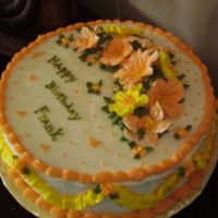 My Brother In Law B-Day Cake First time I used royal icing to make flowers, self taught. I also added oragnge marmalade inbetween layers